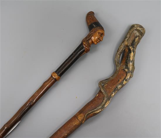 Two carved handled walking sticks longest 92cm